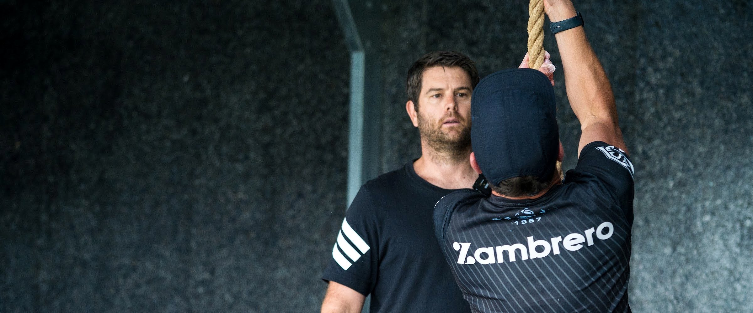 Aaron Zimmerman coaching an athlete on the wall at A2Z Strength, New Plymouth